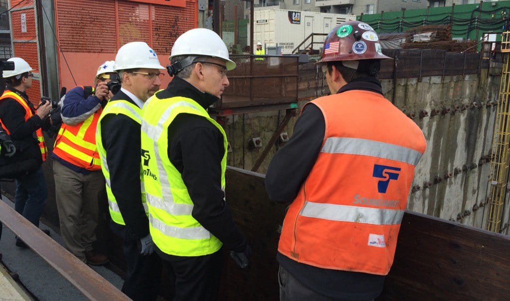 Mr. Rogoff and Mr. Constantine speaking with Sound Transit staff and observing the Roosevelt Station construction pit. (King County)