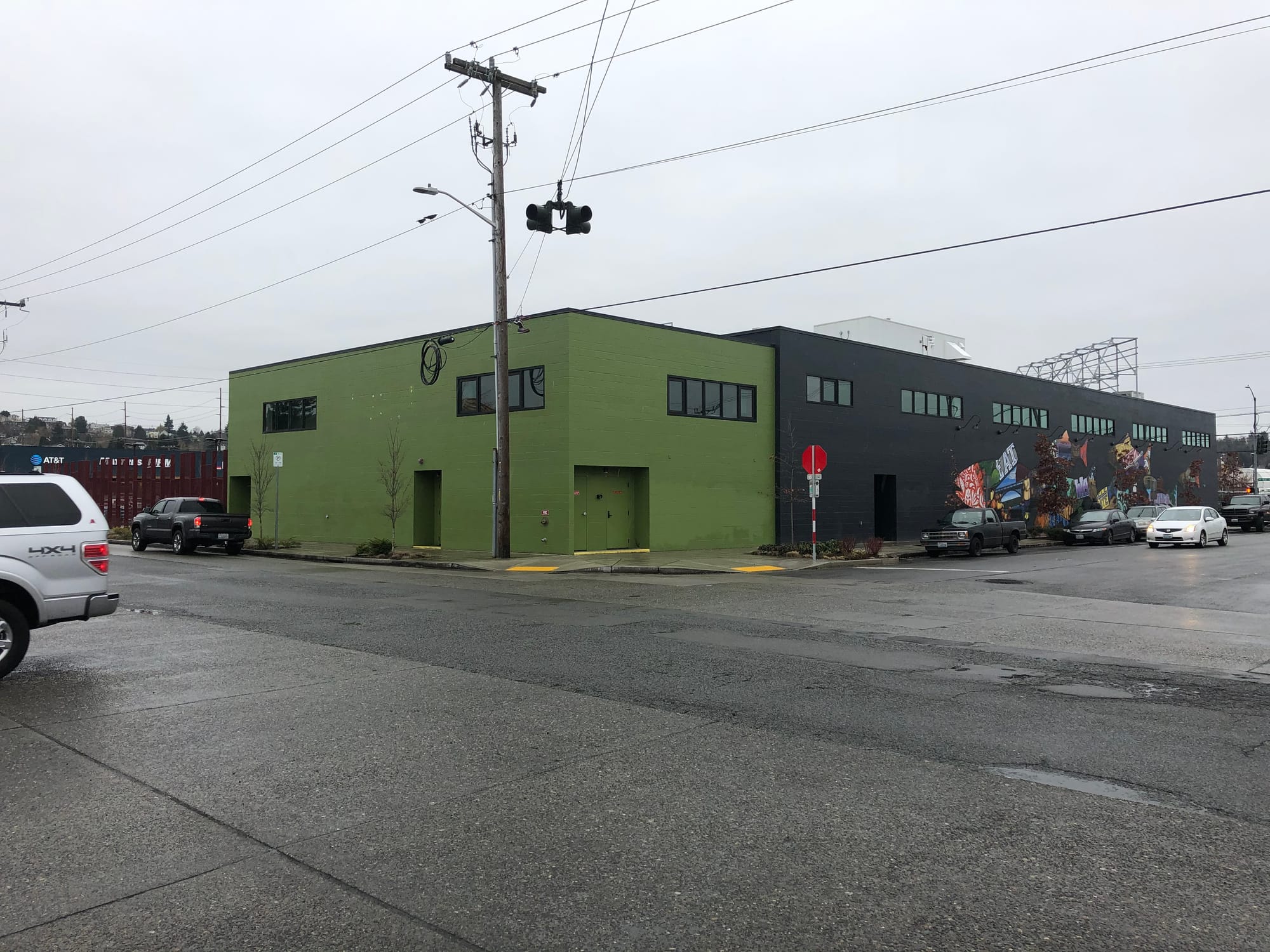 Photograph of a grocery store at an intersection with new curbs and road replacement. The grocery store is empty.