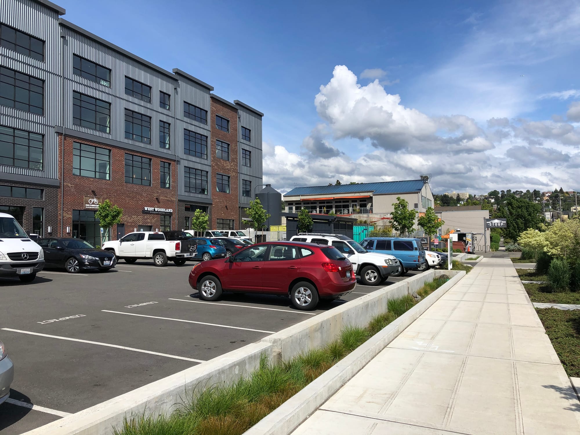 The, unfortunately parking heavy, south side of the West Woodland Business Park with Stoup Brewing next door. Urban Family Brewing is across the street, Obec Brewing immediately to the left, and Reubens Brewing around the corner. The block is zoned Industrial General and completely within the BINMIC. (Photo by the author)