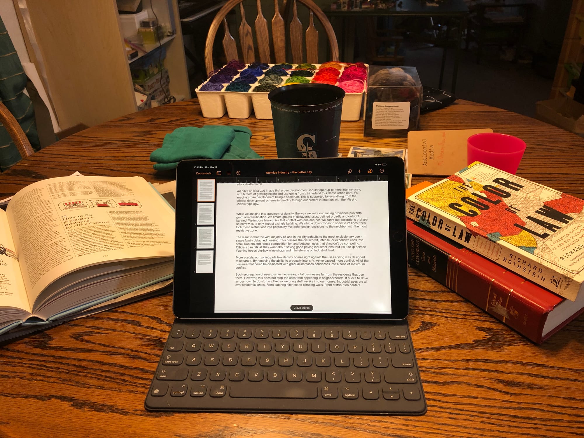 The author's dining room table. While not a continuous zone of maximum conflict, it's gotten a workout over the last ten weeks. This mixed-use space requires flexibility in juggling the education of two elementary schoolers, Zoom calls, raucous ideas in urbanism, and so very much yarn. And that's between breakfast and dinner. Fiber by Canon Hand Dyes. (Photo by author)