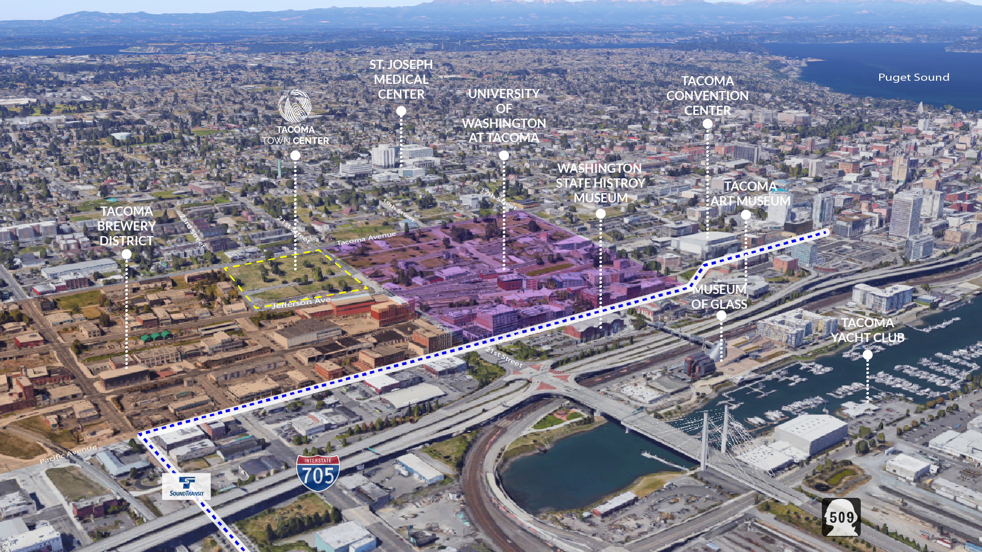 An aerial photo shows the Tacoma Town Center site in central Tacoma with I-705 looming in the foreground taking up much of the waterfront space.