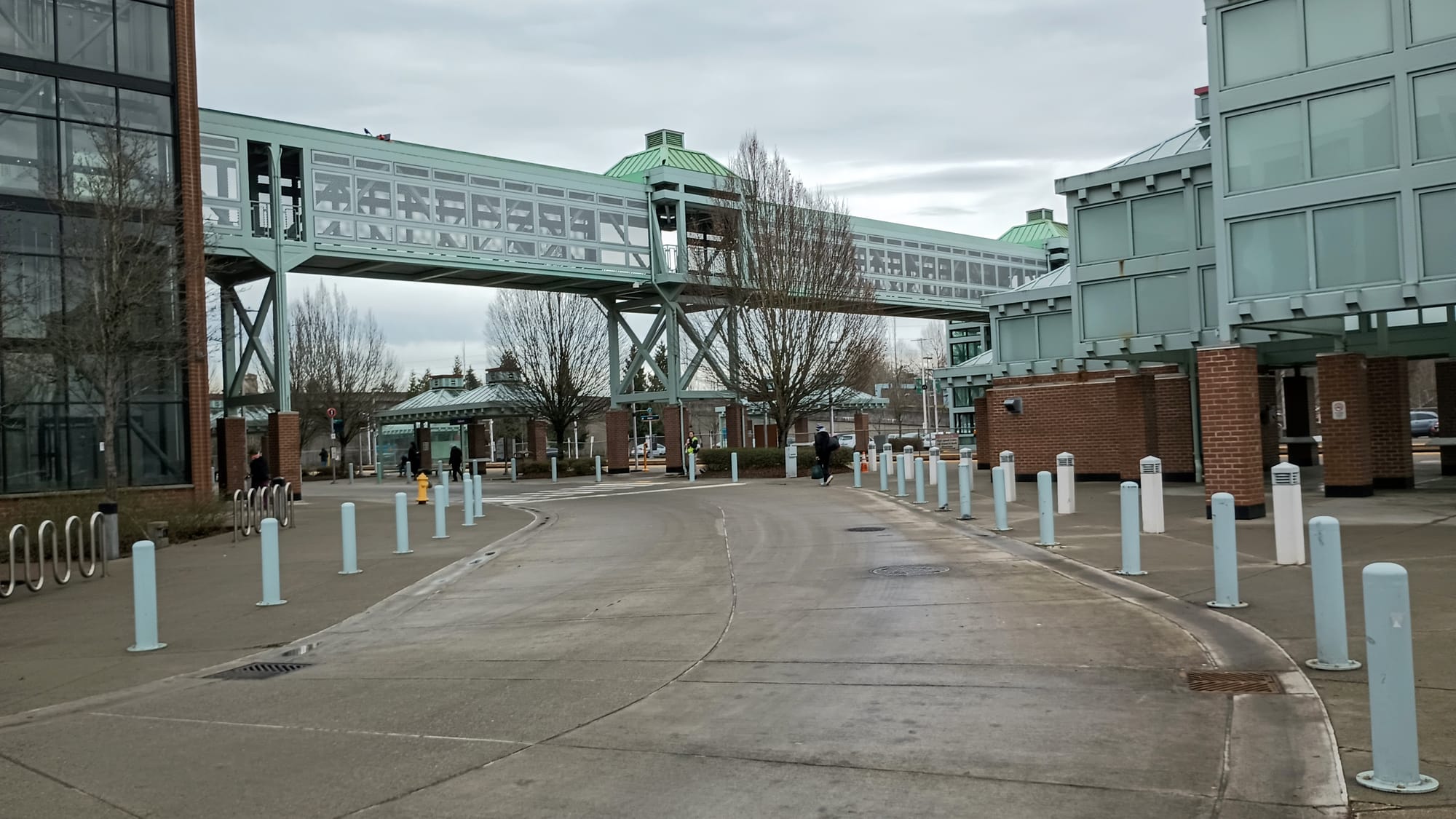 A pathway for vehicles clearly delineated from pedestrian space with bollards