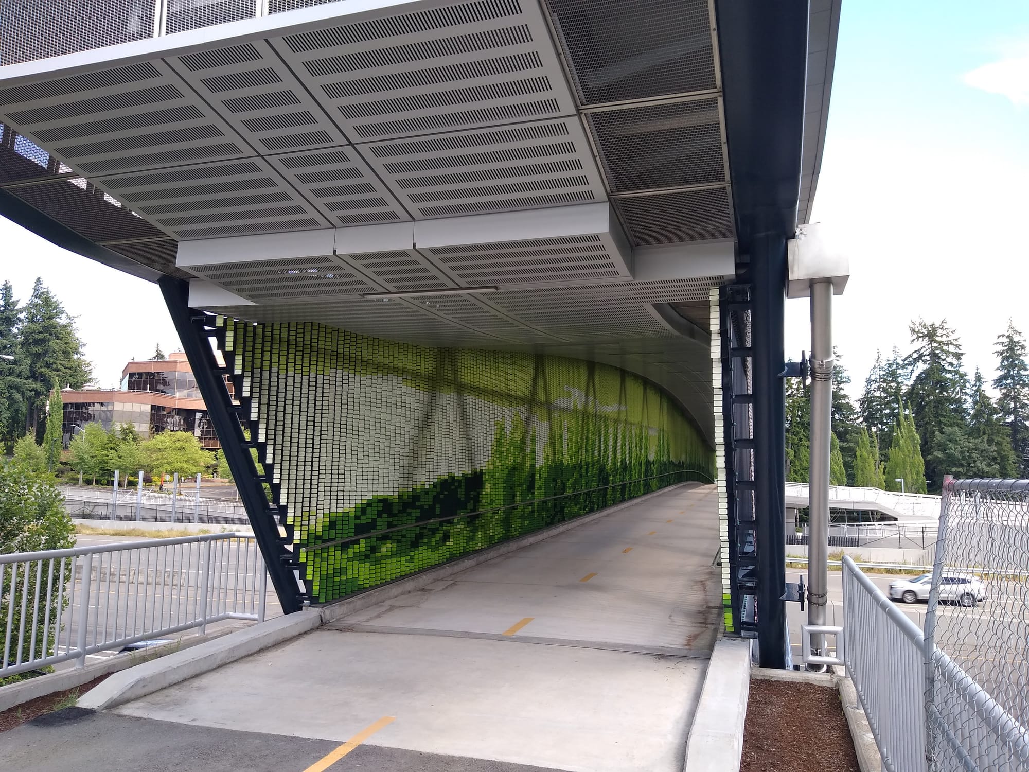 Multi-use trail bridge at the Overlake Station showing new art, a tile installation of 156,000 tiles, by Seattle artist, Leo Berk.